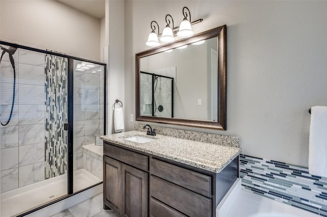 bathroom with a shower stall and vanity