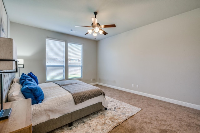 bedroom with carpet flooring, ceiling fan, visible vents, and baseboards