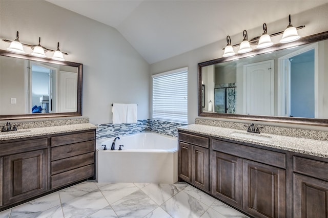 bathroom with lofted ceiling, two vanities, a sink, a shower stall, and a bath