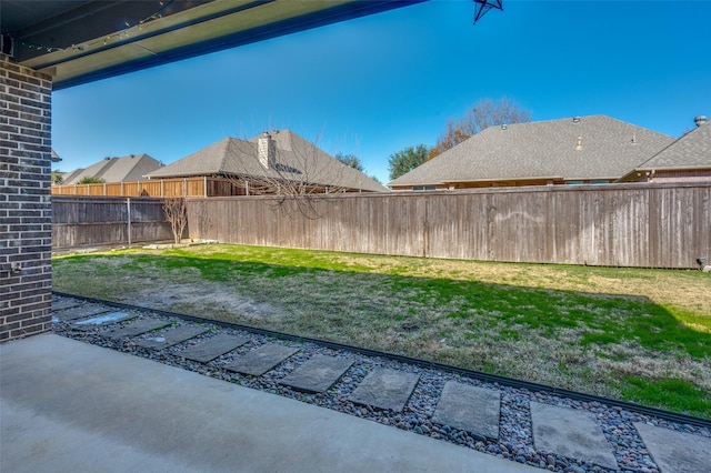 view of yard with a fenced backyard