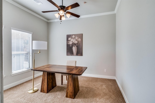 carpeted office space featuring ceiling fan and ornamental molding