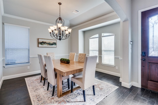 dining room featuring dark wood-type flooring, visible vents, and baseboards