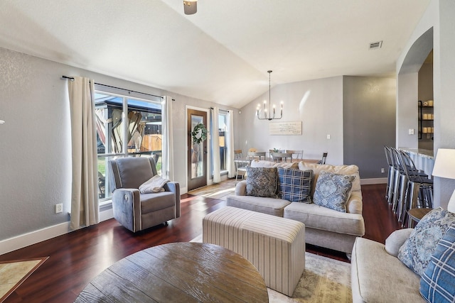 living room featuring a chandelier, dark hardwood / wood-style flooring, and vaulted ceiling