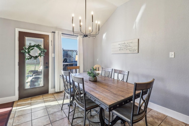 tiled dining area with lofted ceiling and a chandelier