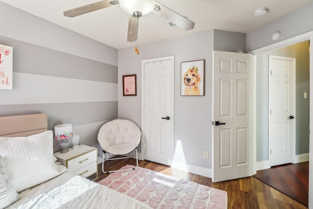 bedroom with ceiling fan and dark hardwood / wood-style floors