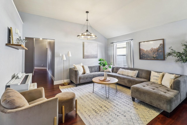 living room featuring vaulted ceiling, a chandelier, and dark hardwood / wood-style floors