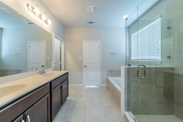 bathroom featuring tile patterned flooring, vanity, and separate shower and tub