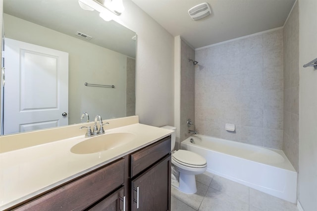 full bathroom featuring tile patterned floors, vanity, tiled shower / bath combo, and toilet