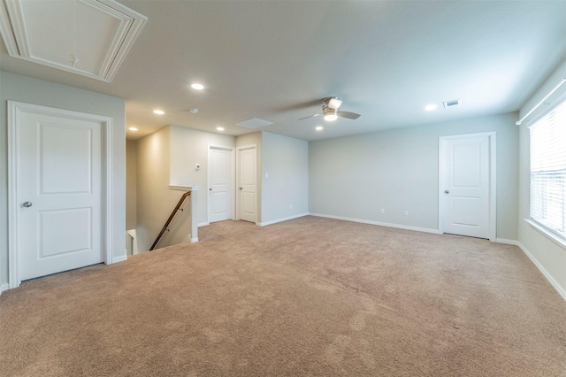 spare room featuring ceiling fan and light colored carpet