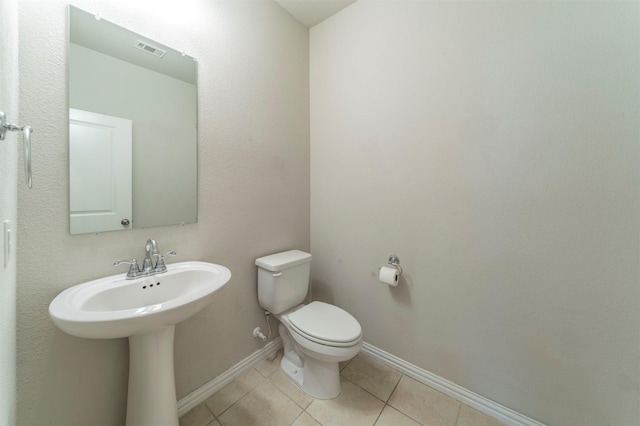 bathroom with tile patterned floors and toilet