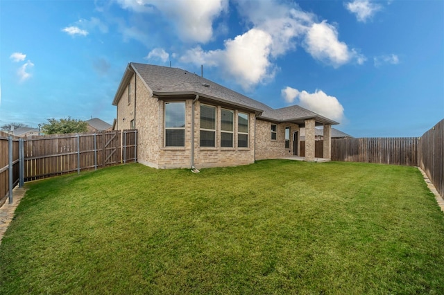 rear view of house with a yard