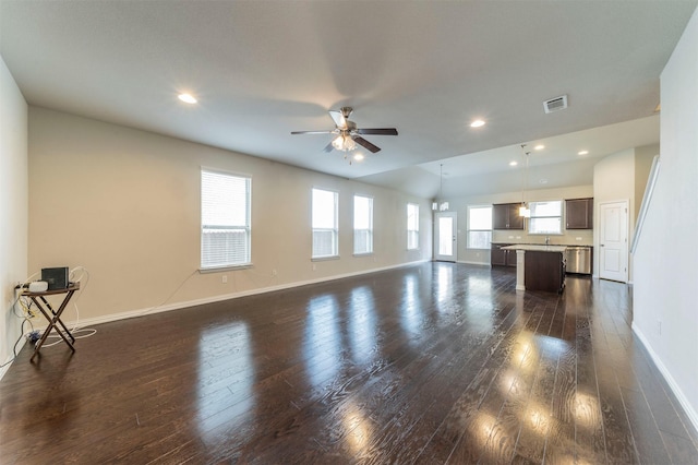 unfurnished living room with ceiling fan, plenty of natural light, and dark hardwood / wood-style floors