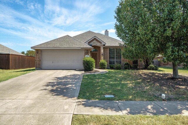 ranch-style home featuring a garage and a front yard