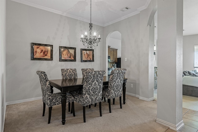 carpeted dining room with an inviting chandelier and ornamental molding