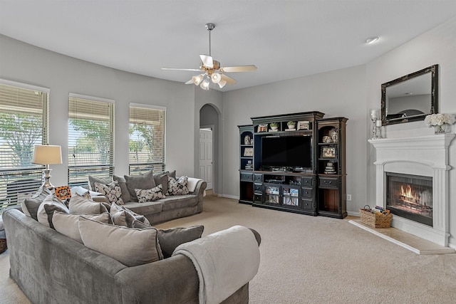 carpeted living room with ceiling fan