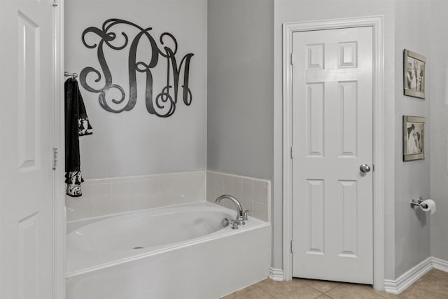 bathroom featuring tile patterned floors and a tub to relax in