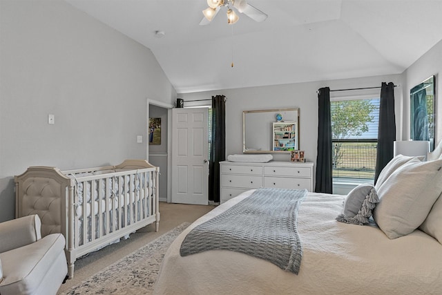 carpeted bedroom featuring ceiling fan and vaulted ceiling