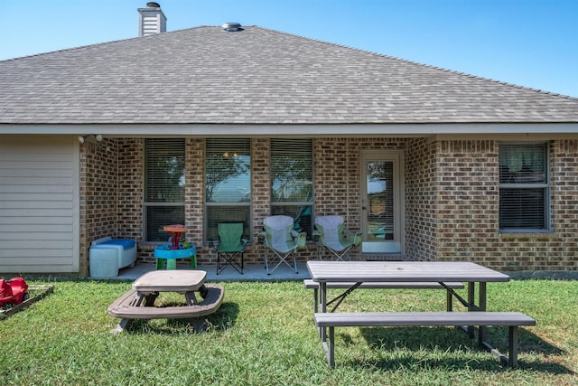 back of house with a lawn