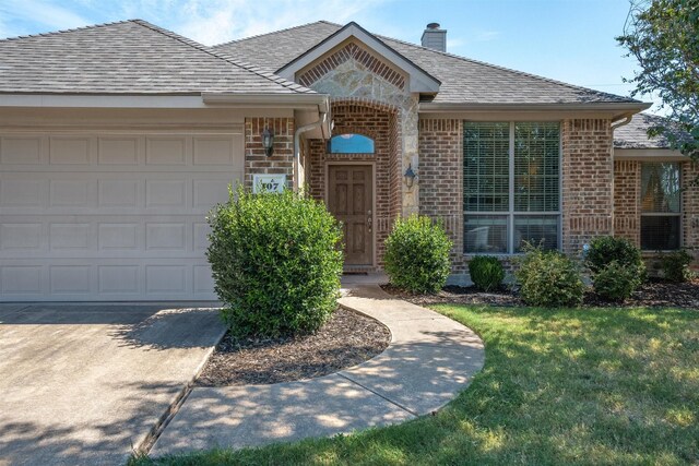 single story home with a garage and a front yard