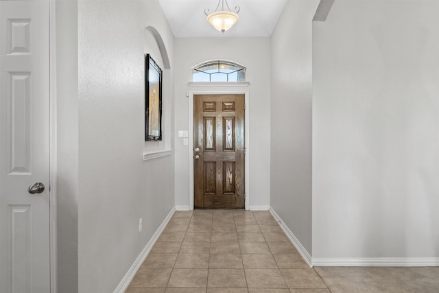 foyer entrance with light tile patterned flooring