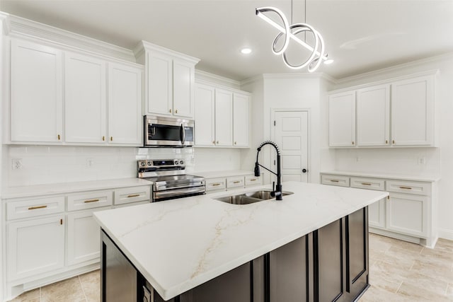 kitchen featuring white cabinets, a center island with sink, sink, and appliances with stainless steel finishes