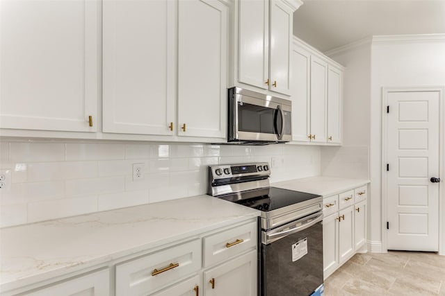 kitchen featuring light stone countertops, stainless steel appliances, white cabinetry, and tasteful backsplash