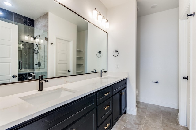 bathroom with tile patterned floors, vanity, toilet, and an enclosed shower