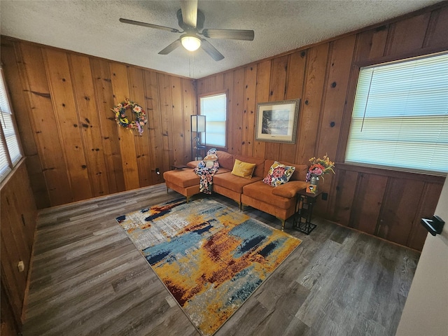 unfurnished living room featuring ceiling fan, plenty of natural light, and a textured ceiling