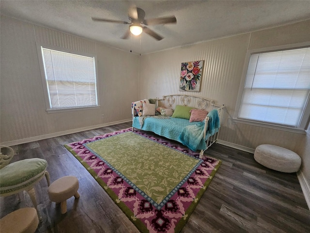 bedroom featuring dark hardwood / wood-style flooring, a textured ceiling, and ceiling fan