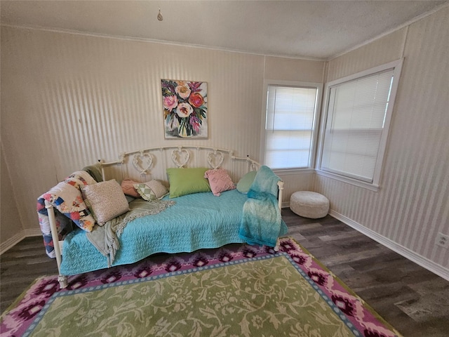 bedroom featuring ornamental molding and dark hardwood / wood-style floors