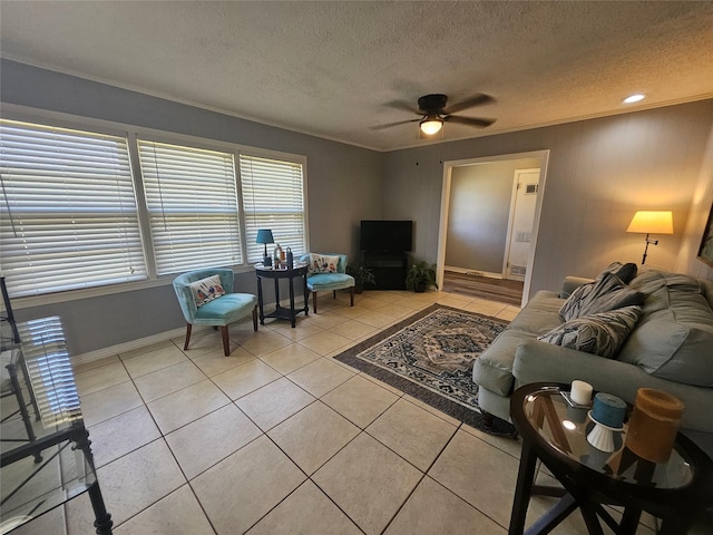 living room with ceiling fan, ornamental molding, a textured ceiling, and light tile patterned flooring