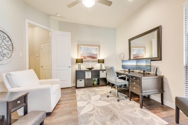 home office featuring ceiling fan and light hardwood / wood-style flooring