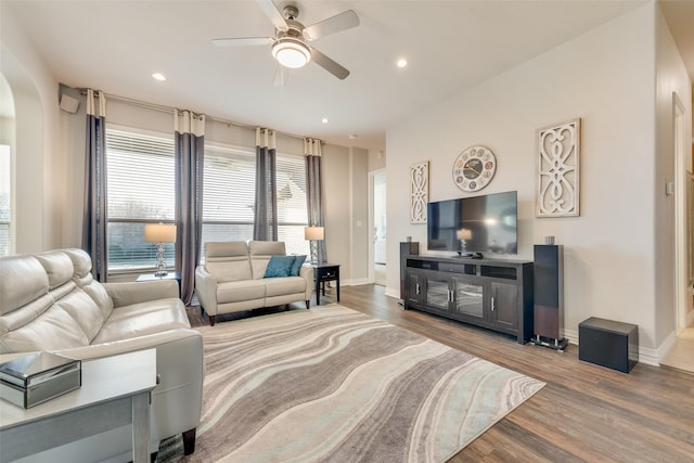 living room with hardwood / wood-style flooring and ceiling fan