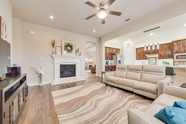 living room featuring hardwood / wood-style flooring and ceiling fan