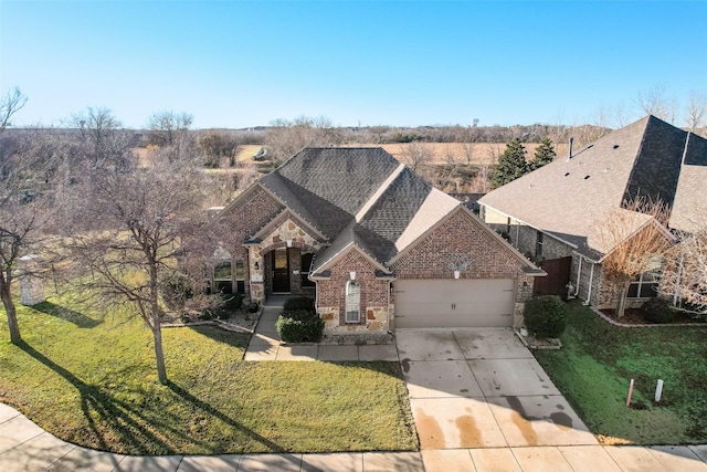 view of property with a garage and a front yard