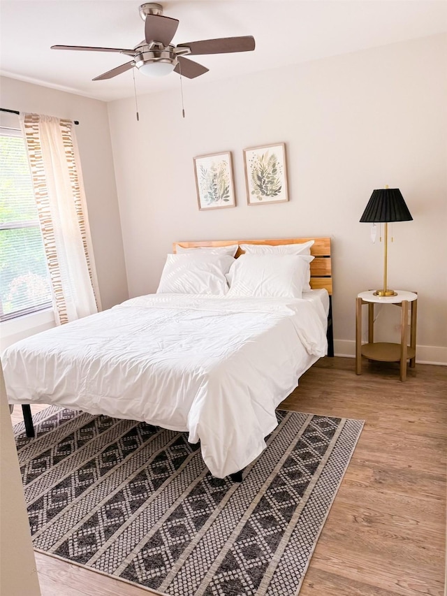 bedroom featuring ceiling fan and light hardwood / wood-style floors