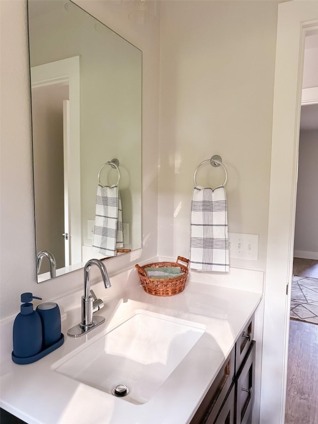 bathroom with vanity and hardwood / wood-style flooring