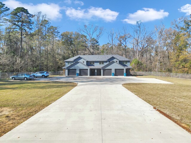 view of front of property featuring a front lawn and a garage