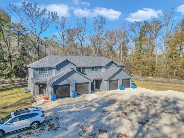 view of front of house with a garage and a front yard