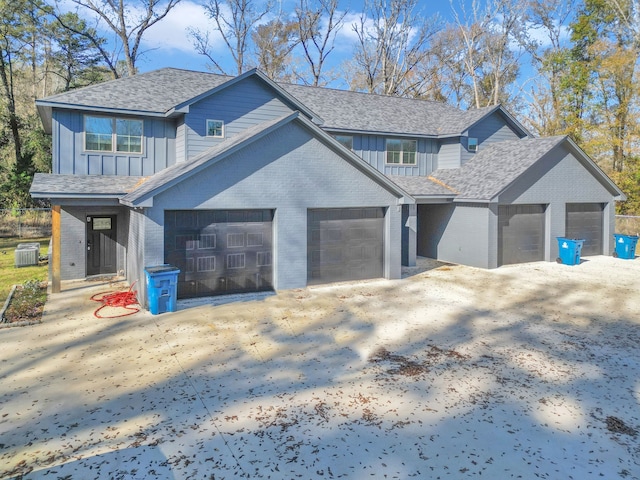 view of home's exterior with cooling unit and a garage