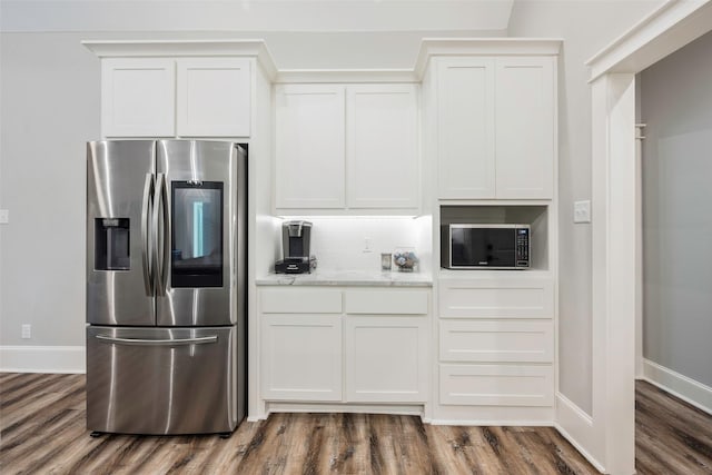 kitchen with white cabinetry, wood-type flooring, light stone countertops, and stainless steel fridge with ice dispenser