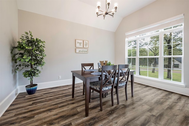 dining room featuring dark wood-type flooring, a notable chandelier, lofted ceiling, and plenty of natural light