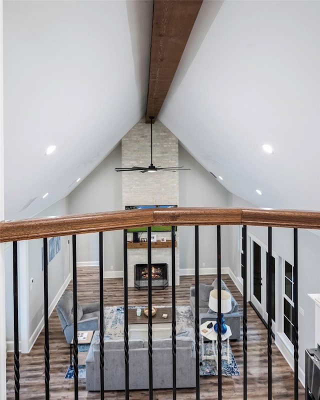 interior space with hardwood / wood-style flooring and lofted ceiling with beams