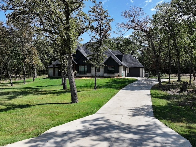 view of front of house featuring a front yard and a garage