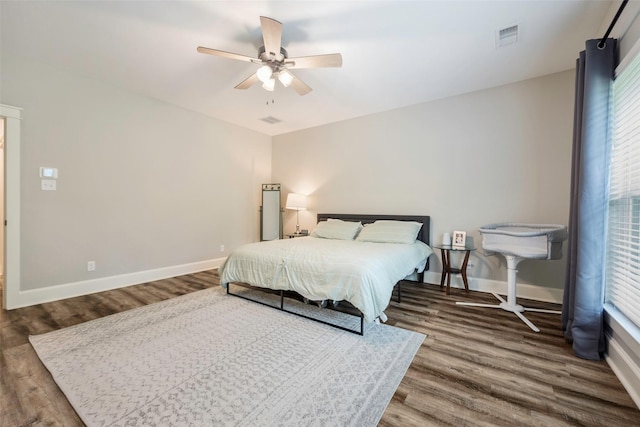 bedroom with wood-type flooring and ceiling fan