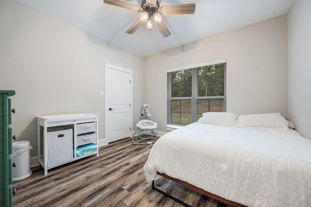 bedroom with dark wood-type flooring and ceiling fan