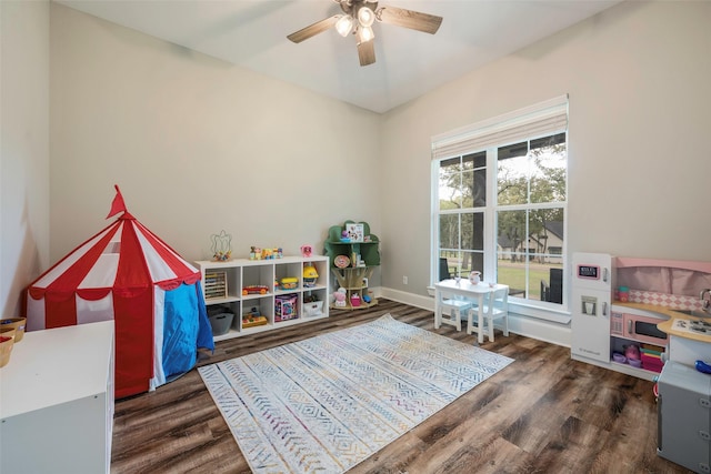 rec room with dark wood-type flooring and ceiling fan