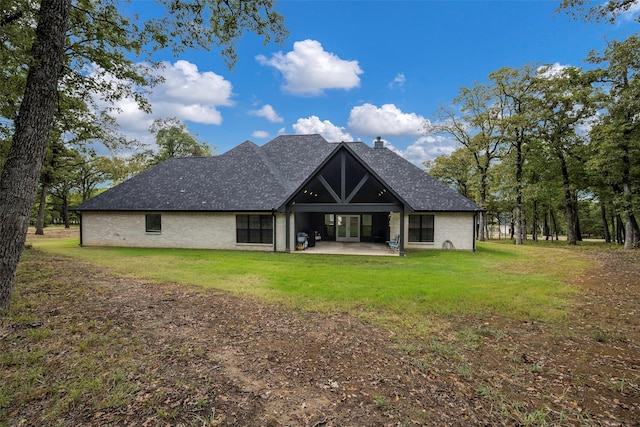 back of property with a patio area and a lawn