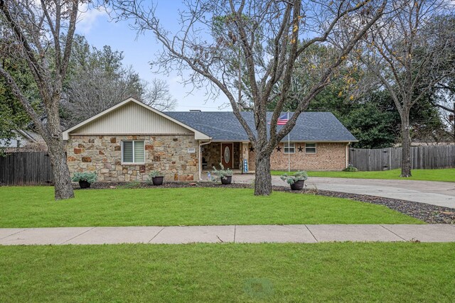 ranch-style home with a front lawn