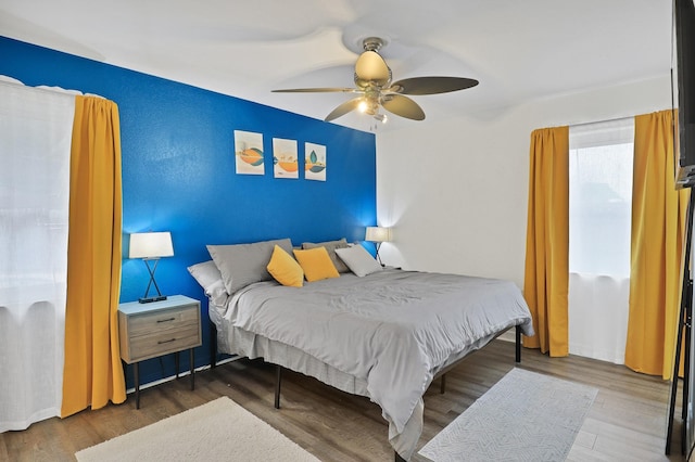 bedroom with wood-type flooring and ceiling fan